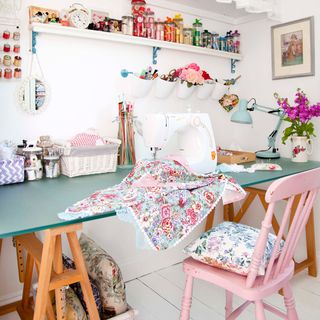 sewing room with flower in vase and table with chair