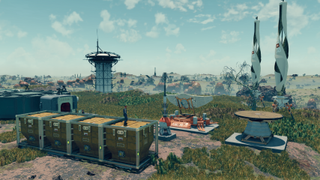 A Starfield outpost on a verdant planet, with visible windmills and storage containers.