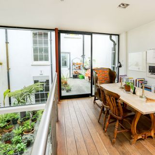 balcony with wooden flooring and dining set