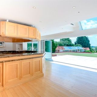 kitchen room with wooden flooring and kitchen cabinets