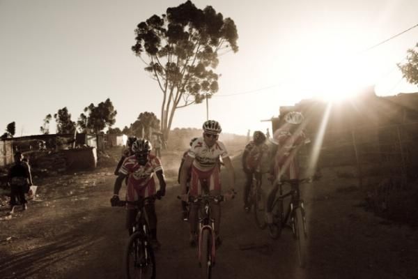 Christoph Sauser rides with the kids