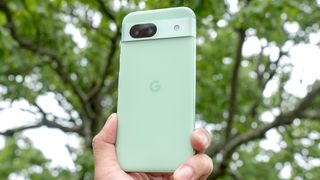 Google Pixel 8a held in the hand showing off it back casing.