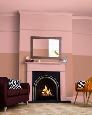 Popsicle pink paint color on top half of living room wall and ceiling highlighting a working fireplace