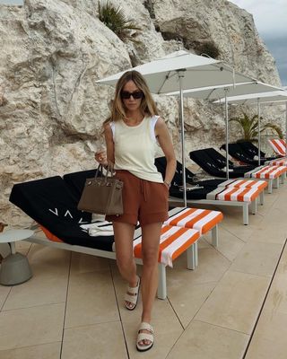 @anoukyve wearing two-strap sandals with linen shorts