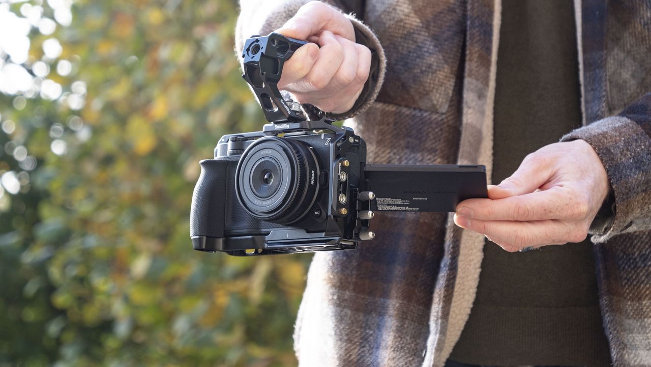 Nikon ZR product photos &ndash; inside a dedicated SmallRig cage, held by user