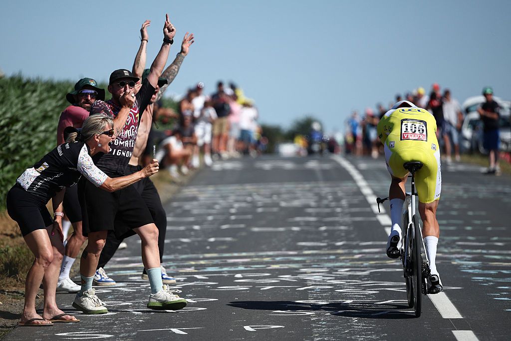Spectators cheer as Alpecin - Deceuninck team's Dutch rider Mathieu van der Poel wearing the overall leader's yellow jersey cycles during the 5th stage of the 112th edition of the Tour de France cycling race, 33 km individual time trial starting and finishing in Caen, northwestern France, on July 9, 2025. (Photo by Anne-Christine POUJOULAT / AFP) (Photo by ANNE-CHRISTINE POUJOULAT/AFP via Getty Images)