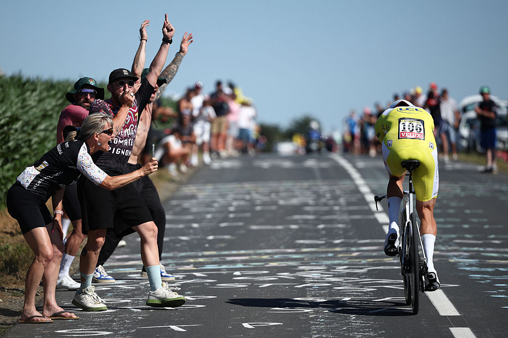 Spectators cheer as Alpecin - Deceuninck team's Dutch rider Mathieu van der Poel wearing the overall leader's yellow jersey cycles during the 5th stage of the 112th edition of the Tour de France cycling race, 33 km individual time trial starting and finishing in Caen, northwestern France, on July 9, 2025. (Photo by Anne-Christine POUJOULAT / AFP) (Photo by ANNE-CHRISTINE POUJOULAT/AFP via Getty Images)