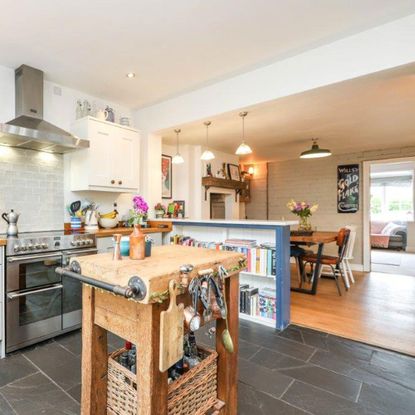 open plan kitchen diner with slate floor and rustic butcher's block