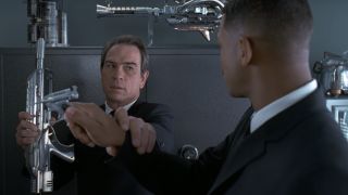 Tommy Lee Jones protects himself from Will Smith holding the Noisy Cricket in Men in Black.