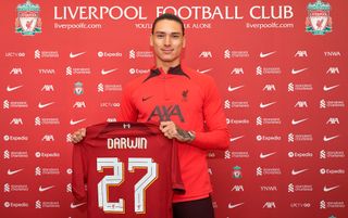 Liverpool striker Darwin Nunez holding his Liverpool shirt after being unveiled
