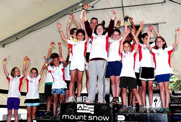 Lea Davison (centre, back) is awarded "most agressive rider" with her Little Bellas helping her accept the award.