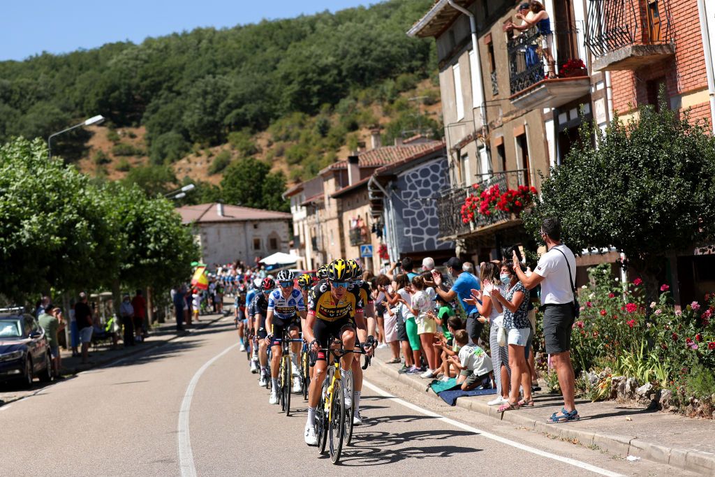 ESPINOSA DE LOS MONTEROS SPAIN AUGUST 16 Robert Gesink of Netherlands and Sepp Kuss of United States and Team Jumbo Visma polka dot mountain jersey leads the peloton on its way through Buuelos de Bureba village while the crowd cheers during the 76th Tour of Spain 2021 Stage 3 a 2028km stage from Santo Domingo de Silos to Espinosa de los Monteros Picn Blanco 1485m lavuelta LaVuelta21 CapitalMundialdelCiclismo on August 16 2021 in Espinosa de los Monteros Spain Photo by Gonzalo Arroyo MorenoGetty Images