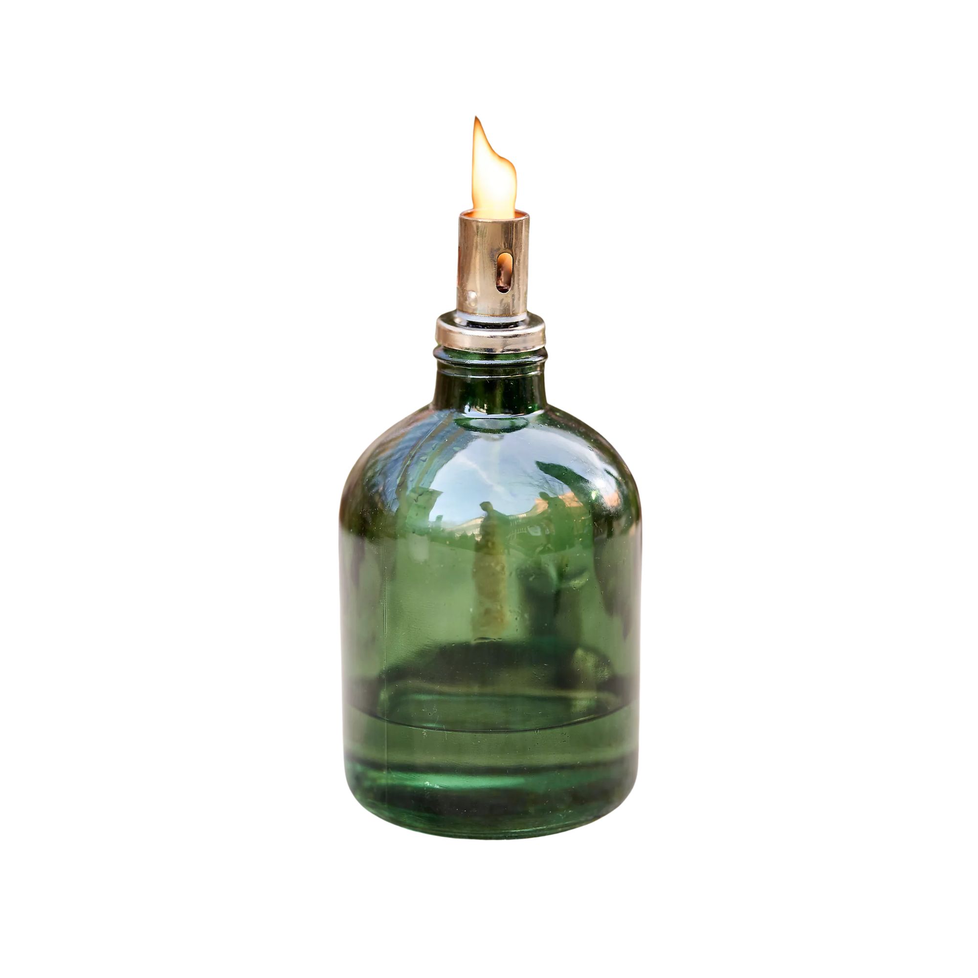 A bottle green oil burning lamp with a flame at the top