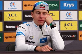 Tadej Pogacar sitting in front of a microphone for an interview, wearing a Richard Mille watch