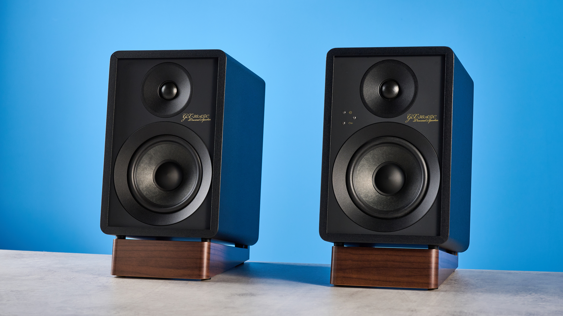 Onkyo GX-30ARC bookshelf speakers photographed on a blue background