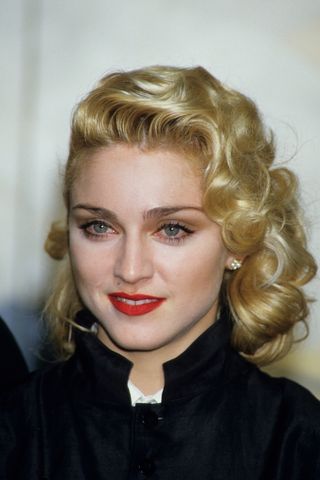 Madonna pictured with black winged eyeliner and a red lip