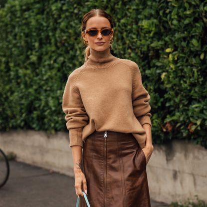 woman wearing turtleneck sweater and leather skirt 