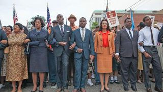 David Oyelowo (center) as Dr. Martin Luther King next to Carmen Ejogo as Coretta Scott King, marching among other Black men and women in Selma