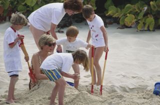 Princess Diana wearing a leopard swimsuit being buried in the sand by Prince William, Prince Harry, and her niece and nephew on Necker Island in 1990