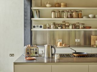 modern kitchen with silver kettle and toaster on island