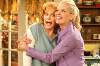 reba mcentire hugs a friend on her sitcom reba