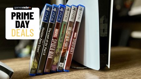PS5 console with games stacked alongside it and Prime Day deals badge