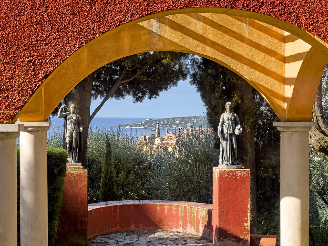 Ferdinand Bac created numerous keyhole views at Les Colombières, to Menton’s old town and Cap d’Ail in the distance. Les Colombières, France. Photographed by Will Pryce for Country Life.