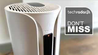 Closeup of Blueair 3-in-1 heater, fan, and air purifier on wooden floor with badge reading 'TechRadar don't miss'