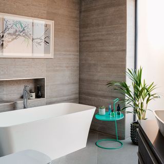 bathroom with cream colour wall tile and white colour bathtub