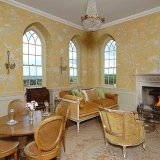 dining room with yellow printed wall and fireplace