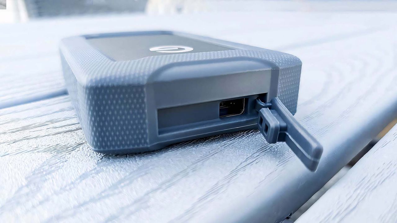 SanDisk Professional G-DRIVE ArmorATD rubber USB-C port door open.