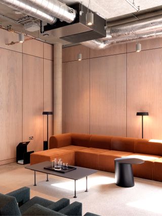 Meeting space with a tan sofa and table