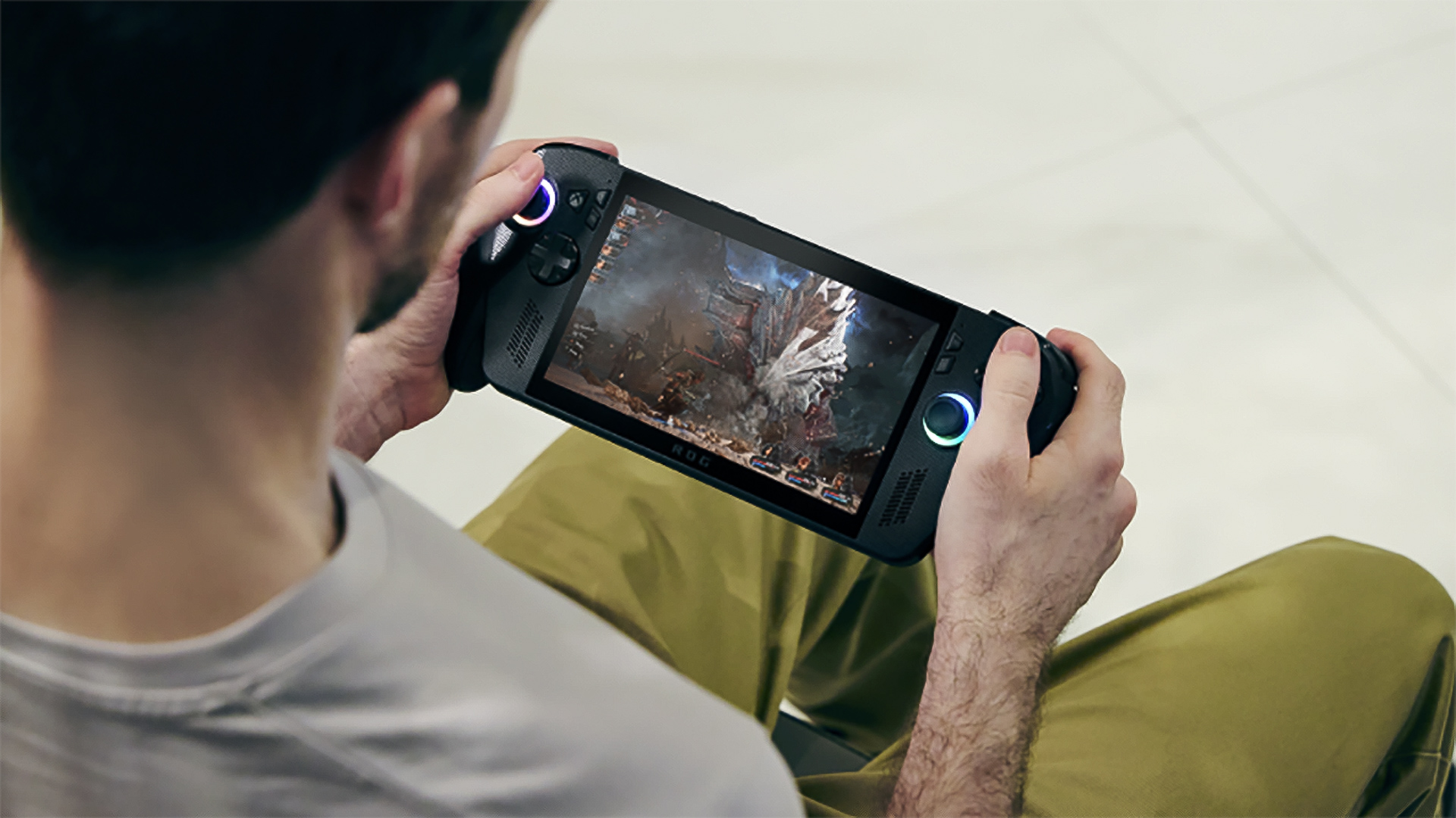Xbox Ally X handheld being played by a man in a chair