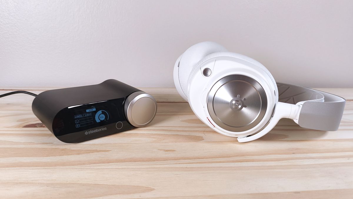 The SteelSeries Arctis Nova Pro and its base station sitting on a wood table