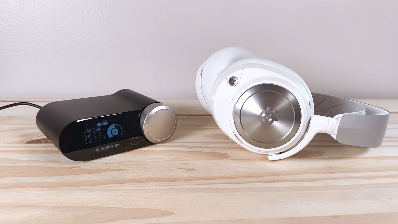The SteelSeries Arctis Nova Pro and its base station sitting on a wood table