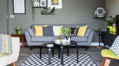 grey living room with sofa and wall pictures