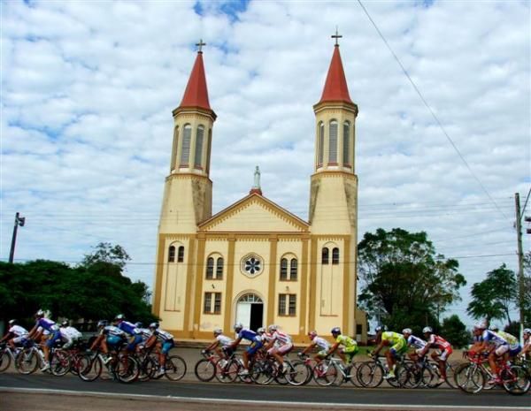The race flys past a church along the stage one route