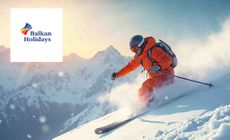 Balkan Holidays logo placed over a man skiing down a slope with mountain and sun set behind him