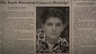 Young Adam Scott, seen in a newspaper clipping for Ben's win as mayor of Partridge, Minnesota