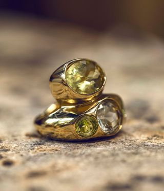 Gold rings with peridots stacked on top of each other