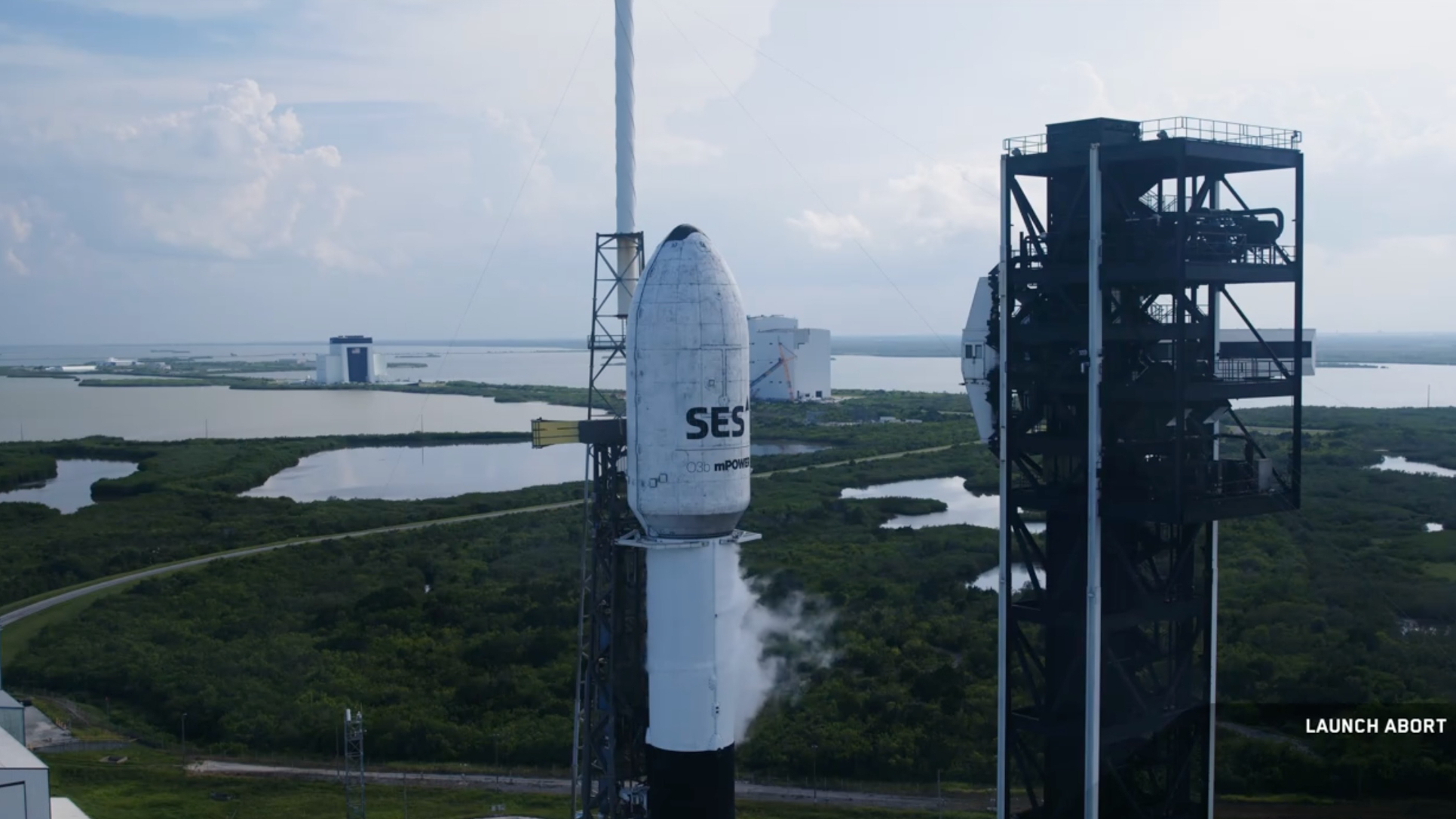 A SpaceX Falcon 9 rocket stands ready to launch two of SES&#039; O3b mPOWER satellites on July 21, 2025. SpaceX called that day&#039;s attempt off.