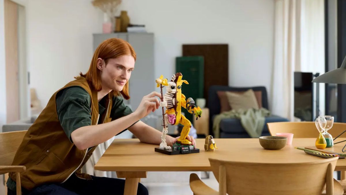 Lego Peely Bone set on a table, being positioned by someone