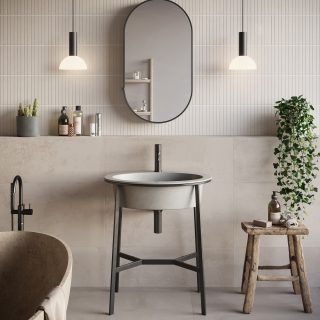 Contemporary bathroom with half heigh ledge and pendant lights either side of a lozenge wall mirror