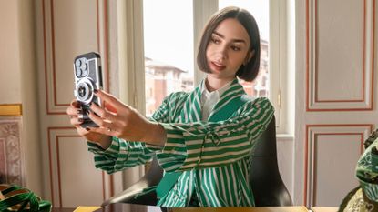 Lily Collins takes a selfie at a desk