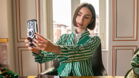 Lily Collins takes a selfie at a desk