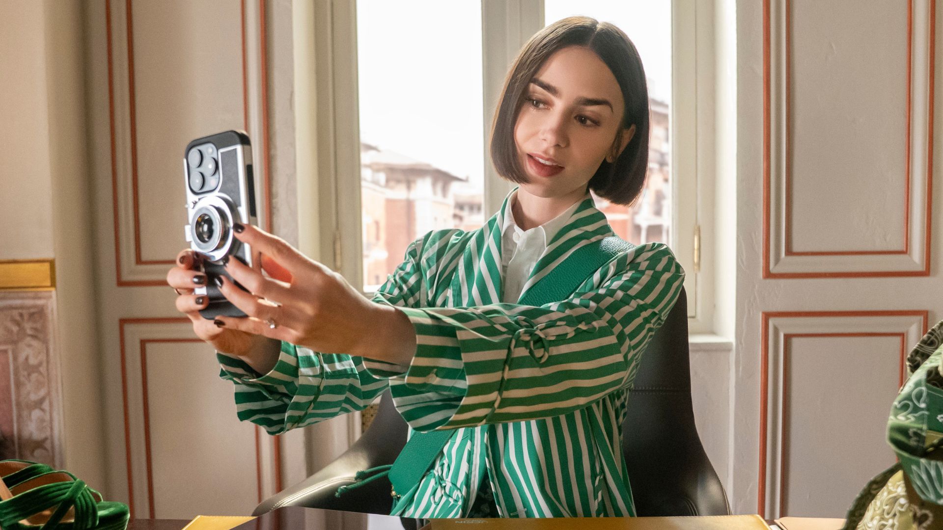 Lily Collins takes a selfie at a desk