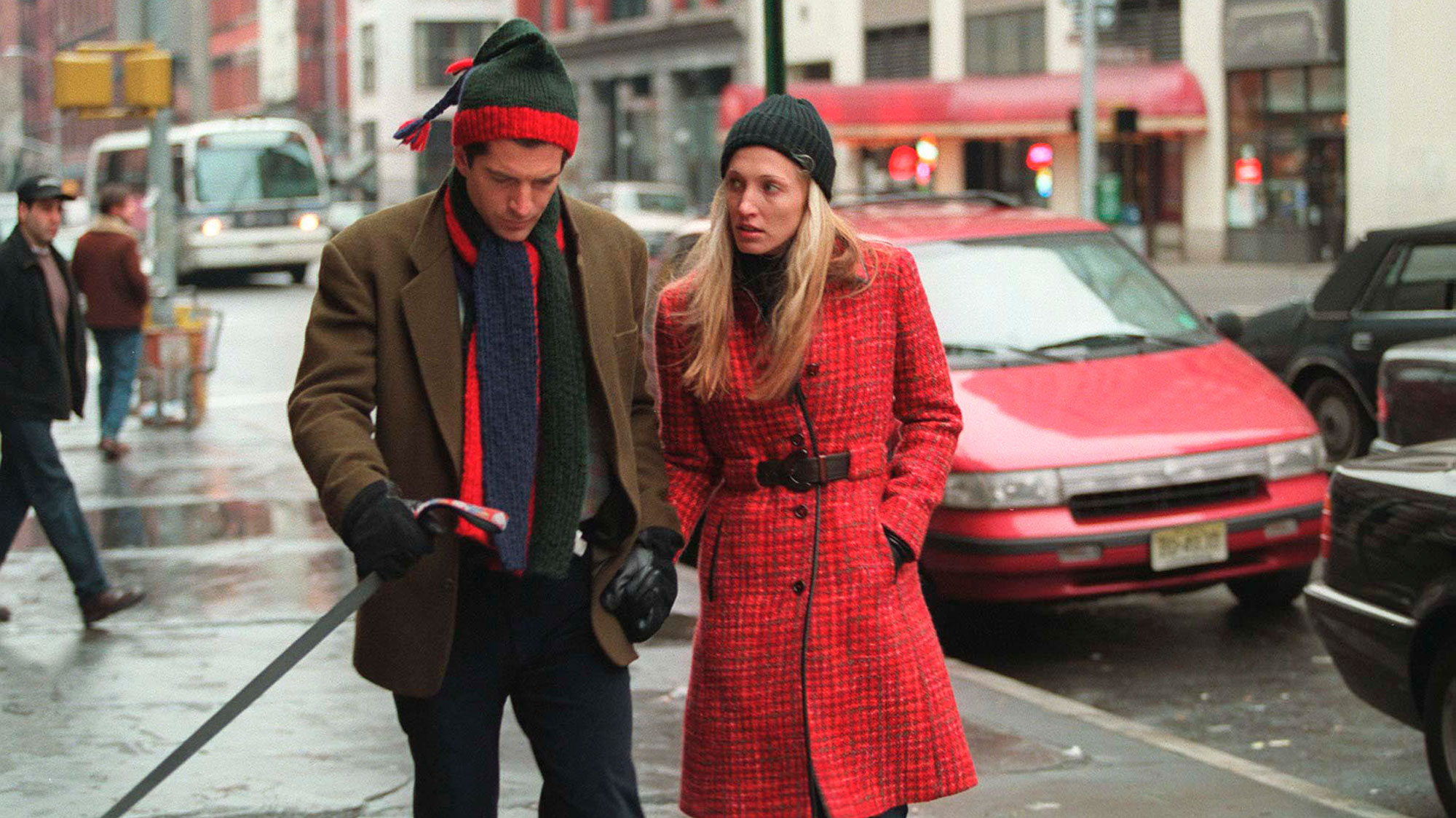 Carolyn Bessette Kennedy wears a red Prada coat