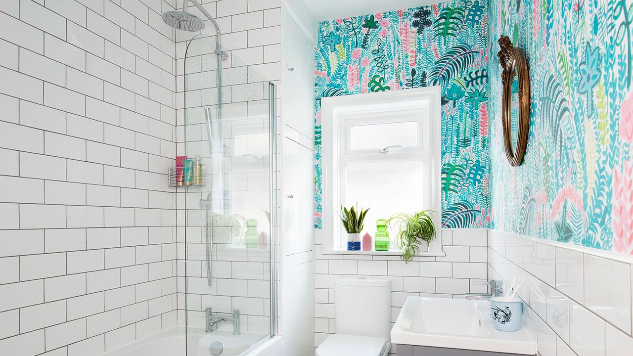 bathroom with pastel floral wallpaper and white tiles