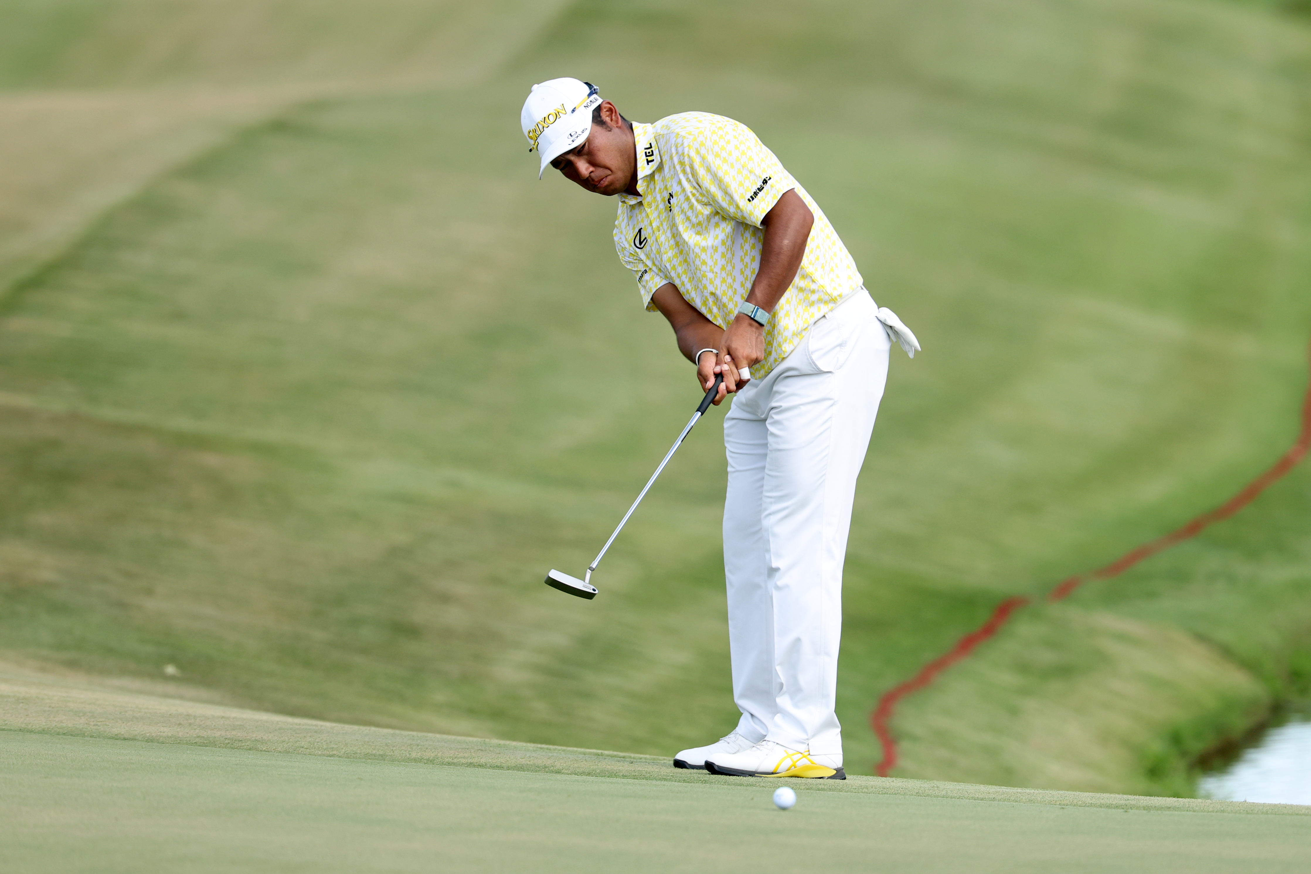 Hideki Matsuyama of Japan putts on the 18th green during the final round of the FedEx St. Jude Championship 2026 at TPC Southwind (Photo by Stacy Revere/Getty Images)