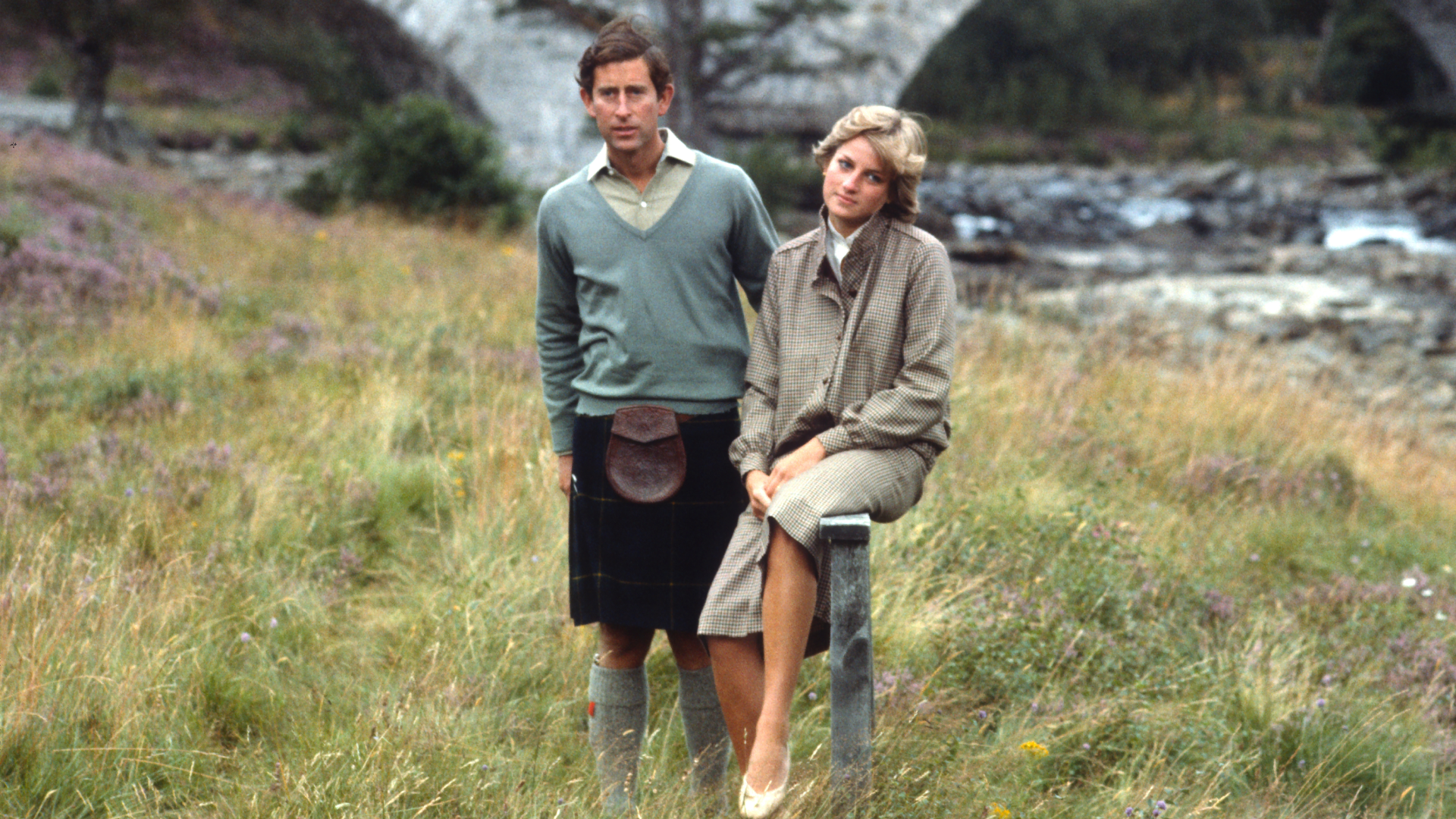 Prince Charles and Princess Diana on honeymoon at Balmoral standing in the grass along the river